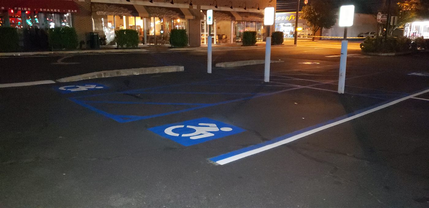 Overnight parking lot striping under work lights